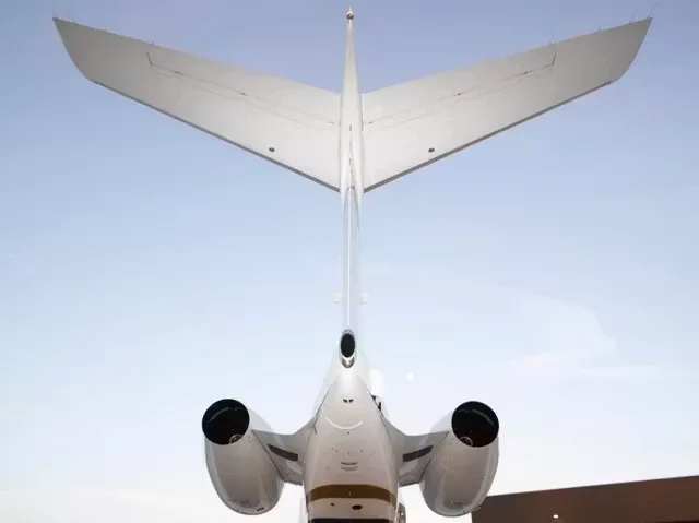 Rear view of a Bombardier Global Express business jet showing the tail and engines.