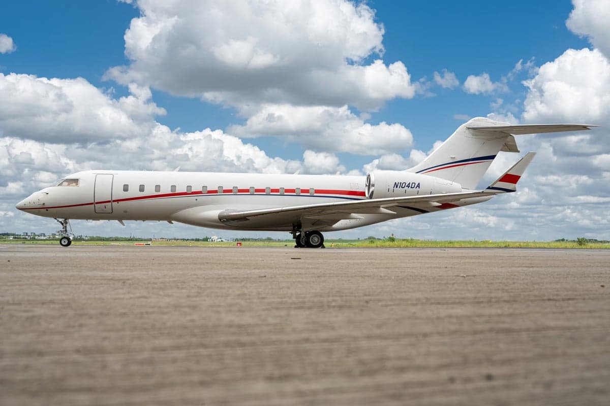 Side view of a Bombardier Global Express aircraft with registration N104AD on the ground.
