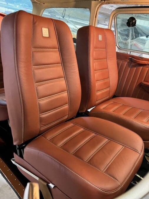 Close-up of the brown leather seats inside the aircraft cabin.