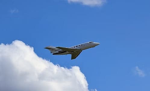 A Hawker jet with registration N998BM in flight.