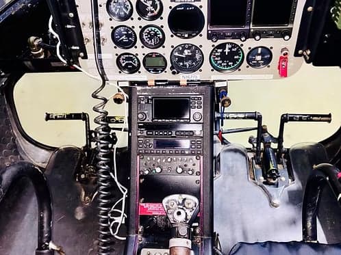 The instrument panel and controls of a Bell 407 helicopter.