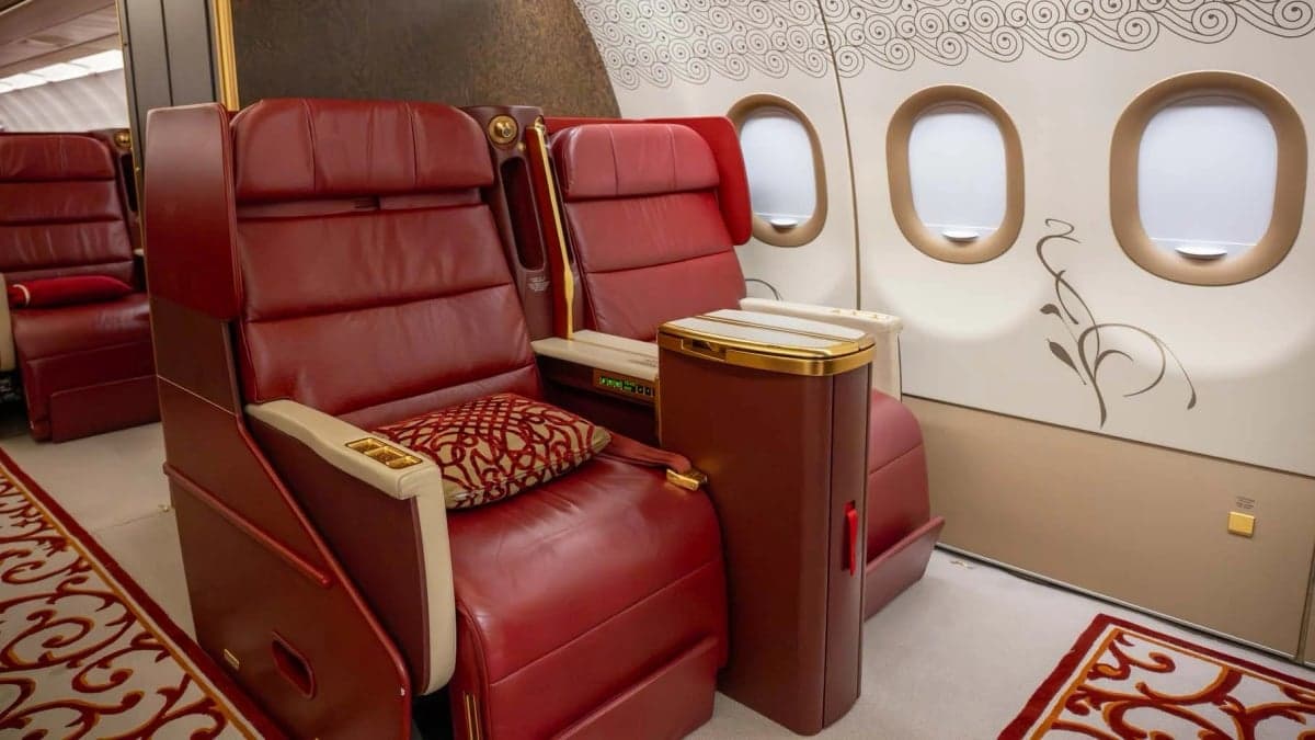 A close-up of red leather seats inside a private jet.