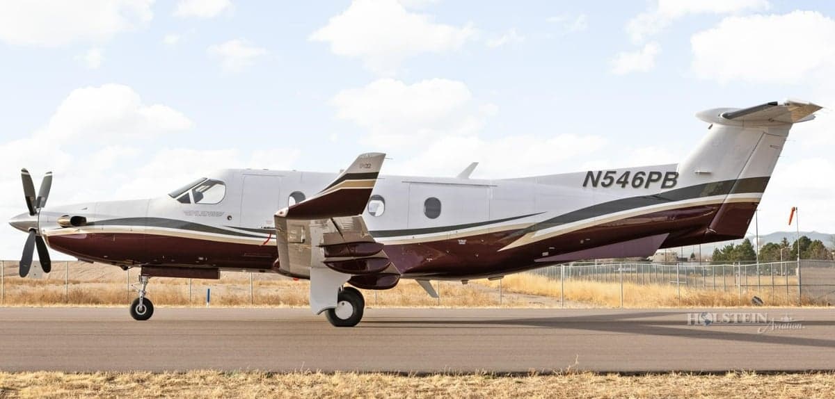 Pilatus PC-12 aircraft N546PB on the runway, side view.