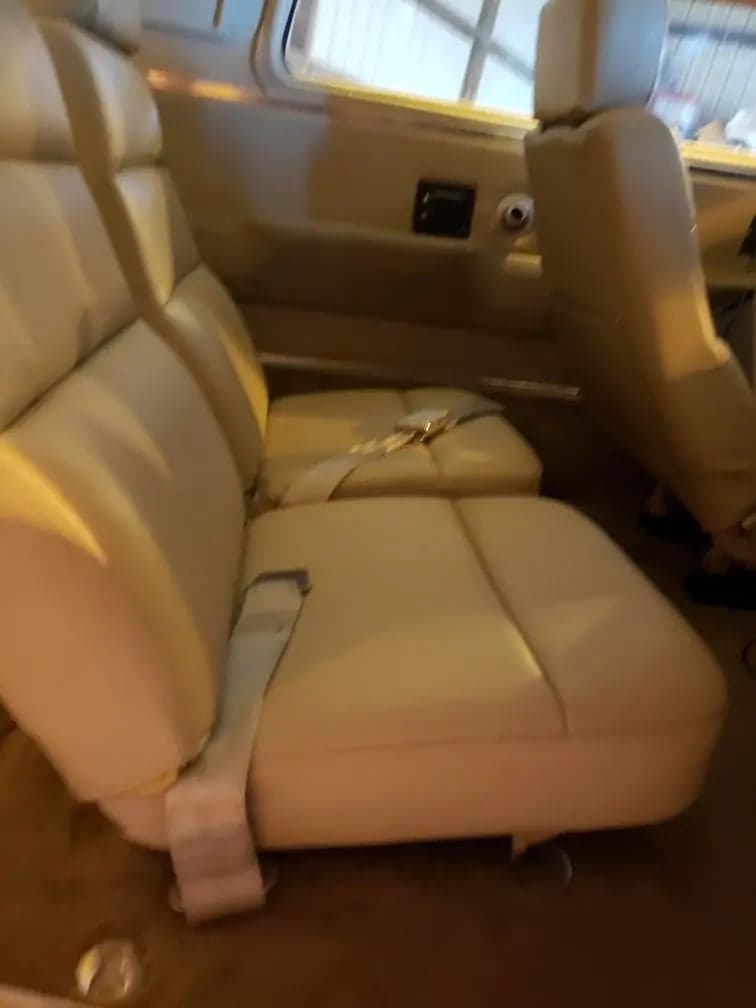 View of the aircraft's cabin seats with seatbelts.