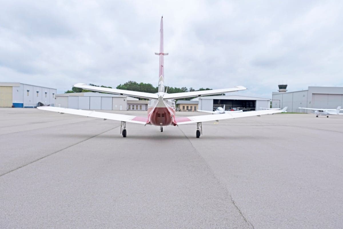 Rear view of the TBM 850 aircraft N836EA on the tarmac.