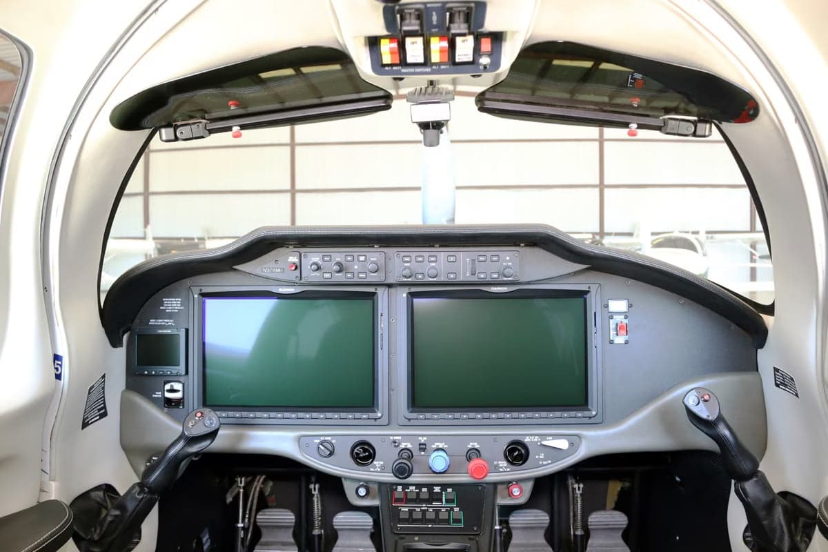 Tail section of a Cirrus SR22T aircraft with registration N974MH inside a hangar.