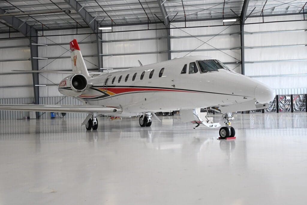 A Citation Sovereign aircraft with tail number N892CW is parked in a hangar.