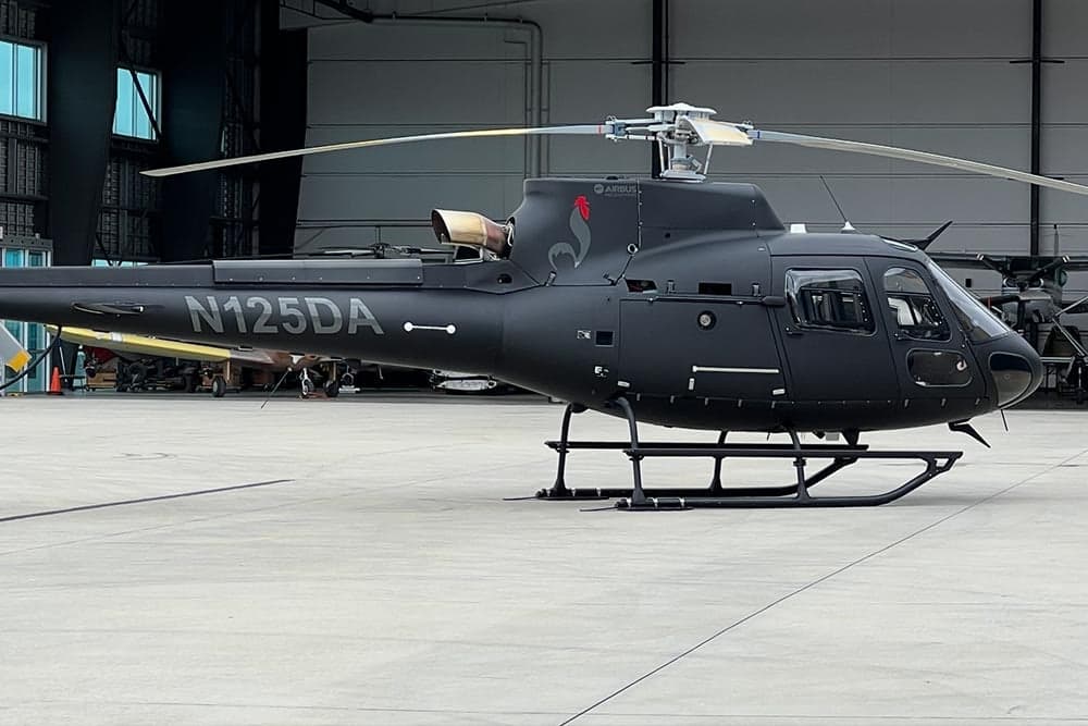 Side view of the N125DA Airbus helicopter on the tarmac.