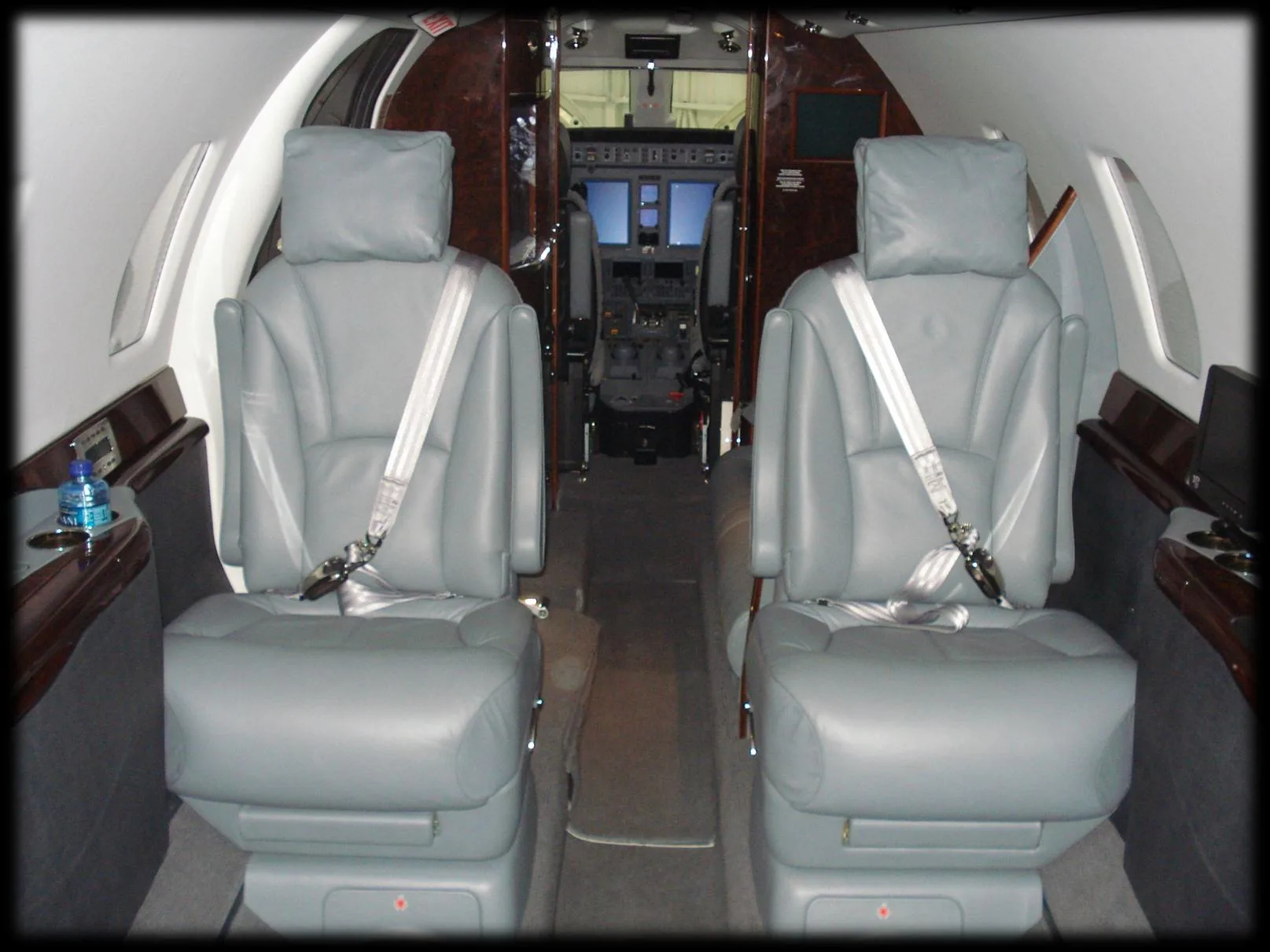 Forward cabin seats with cockpit in the background.