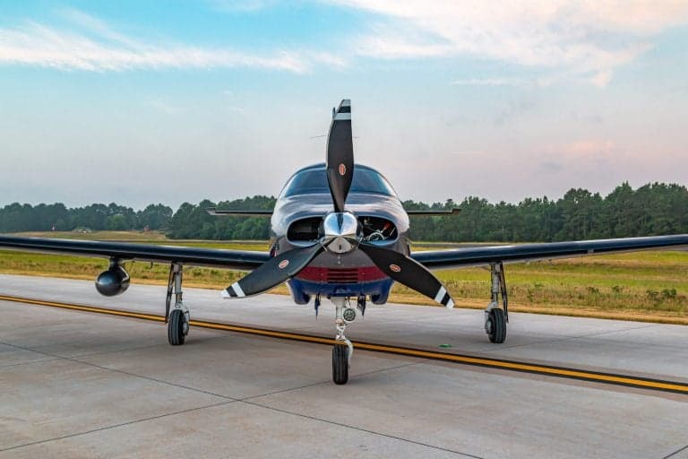 Front view of a Piper Mirage on the runway.