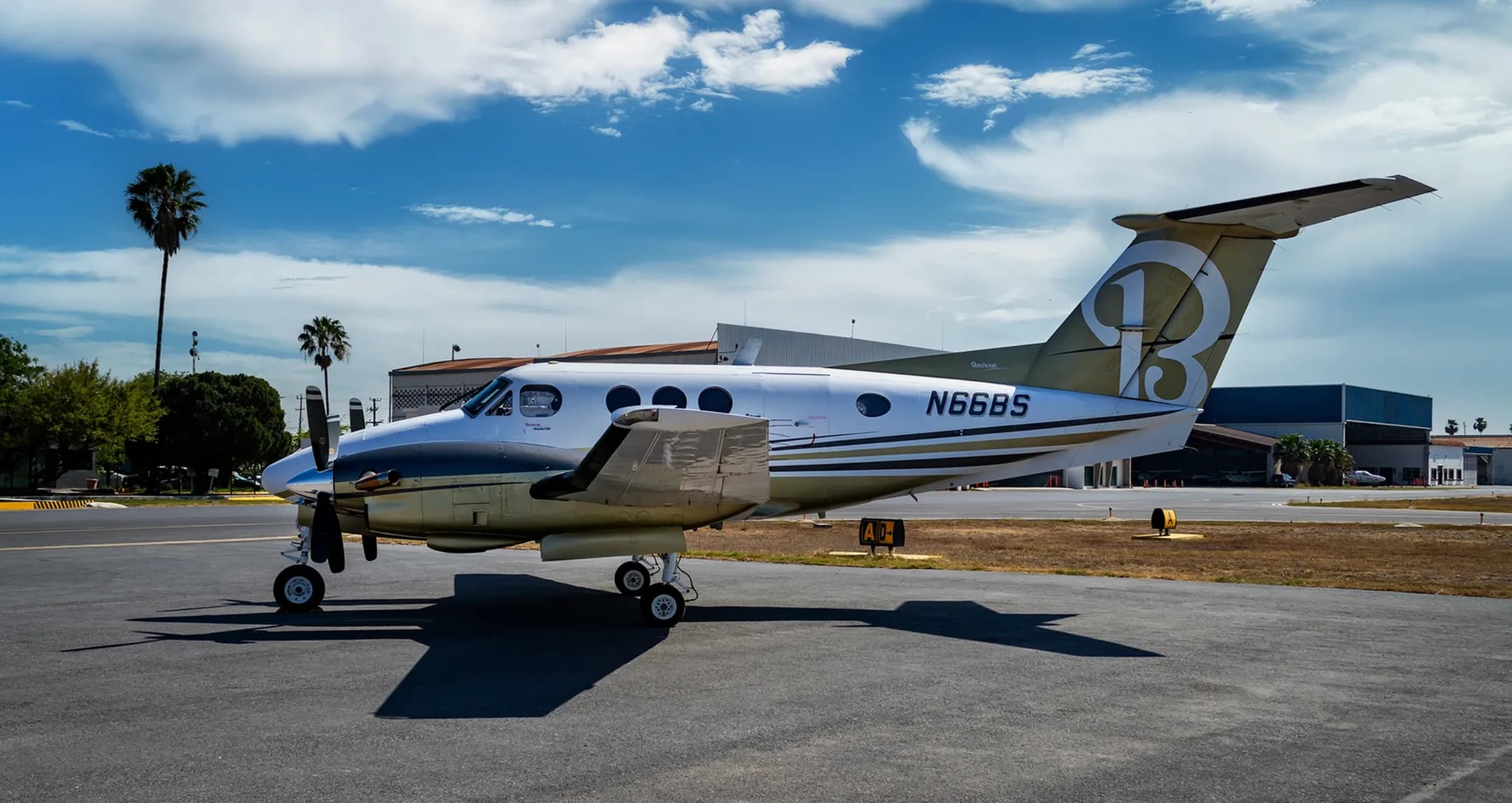 Beechcraft King Air 200, registration N66BS, parked on the tarmac with a large 'B' on the tail.