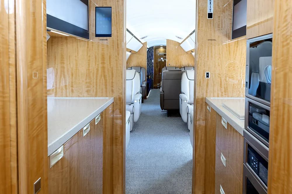 A close-up of the aircraft's galley featuring a sink, faucet, and built-in microwave and oven.