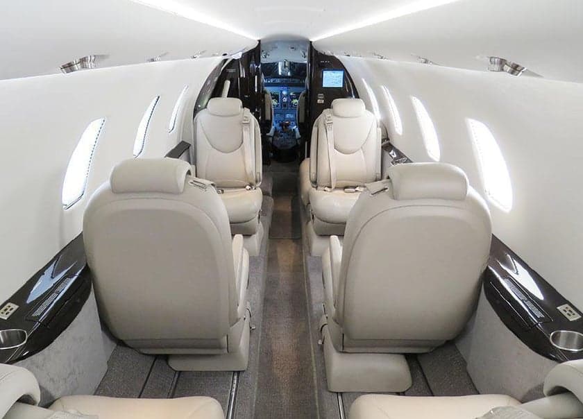 View of the aircraft's interior cabin with leather seats.