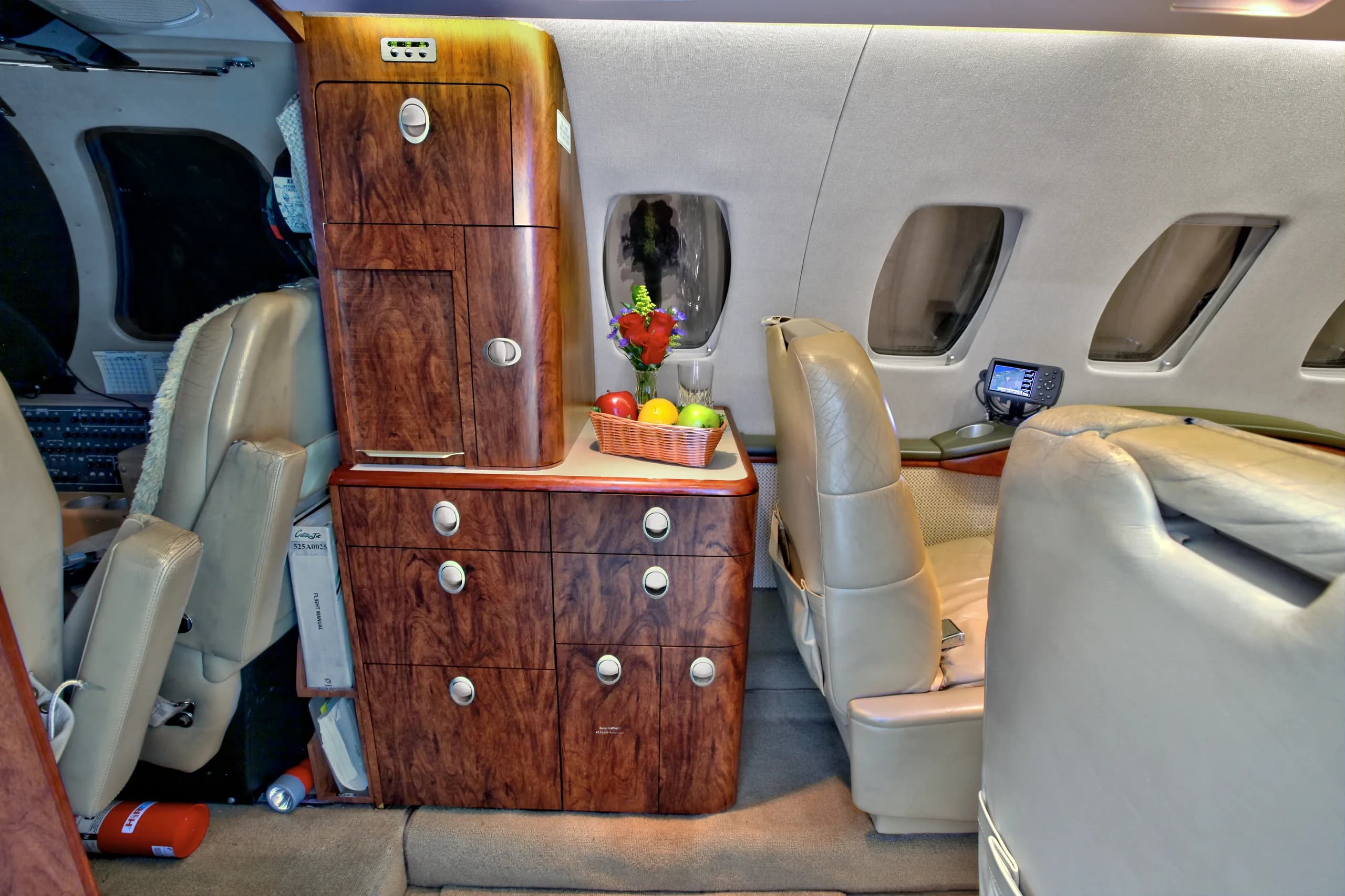 The interior of a Cessna Citation CJ1+ featuring leather seats and wood accents.
