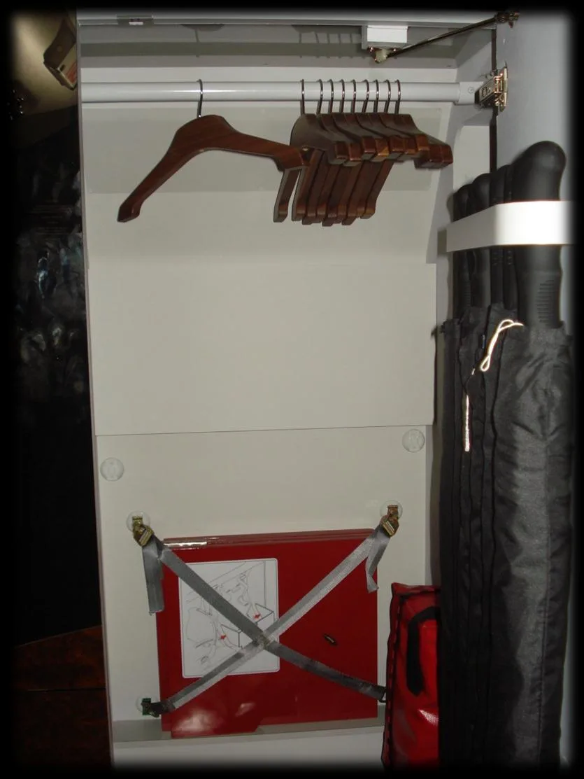 Interior storage compartment with hangers and emergency equipment.