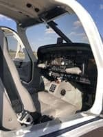 The cockpit of the aircraft features a gray interior and instrument panel.