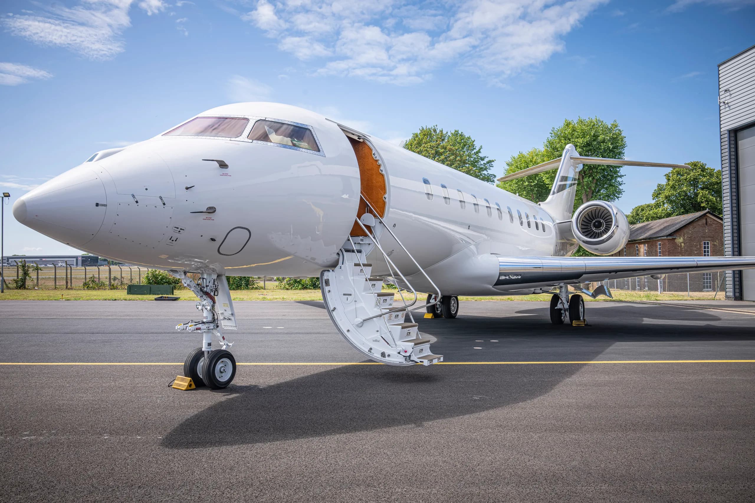 A white Bombardier Global Express with the door open.