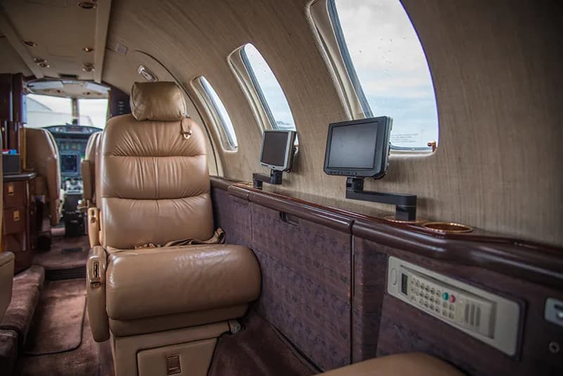 Interior of the Cessna Citation CJ1+ showing leather seats and entertainment system.