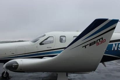 The tail of a TBM 930 aircraft with the model number displayed.