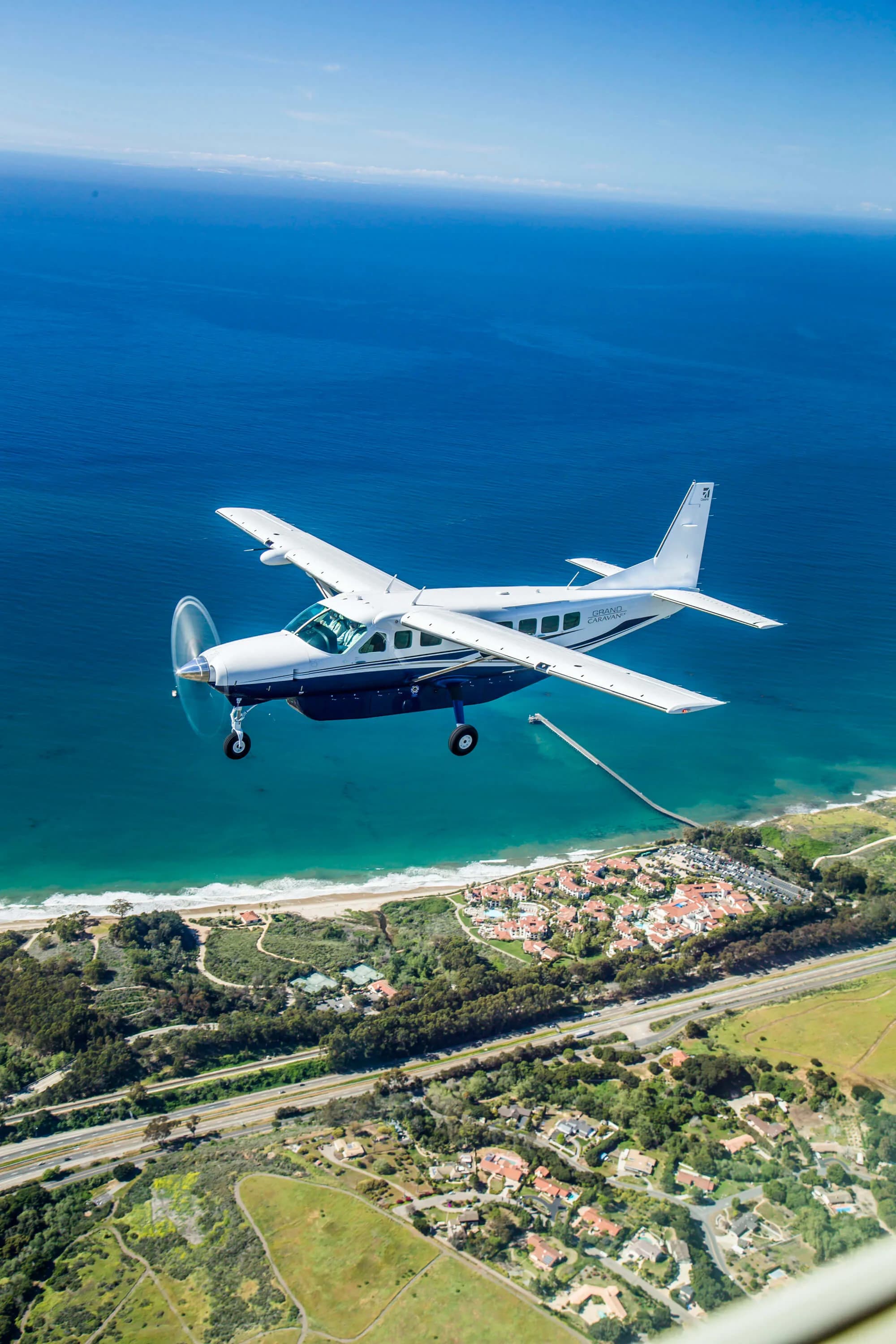 Cessna Grand Caravan in flight over the coast.