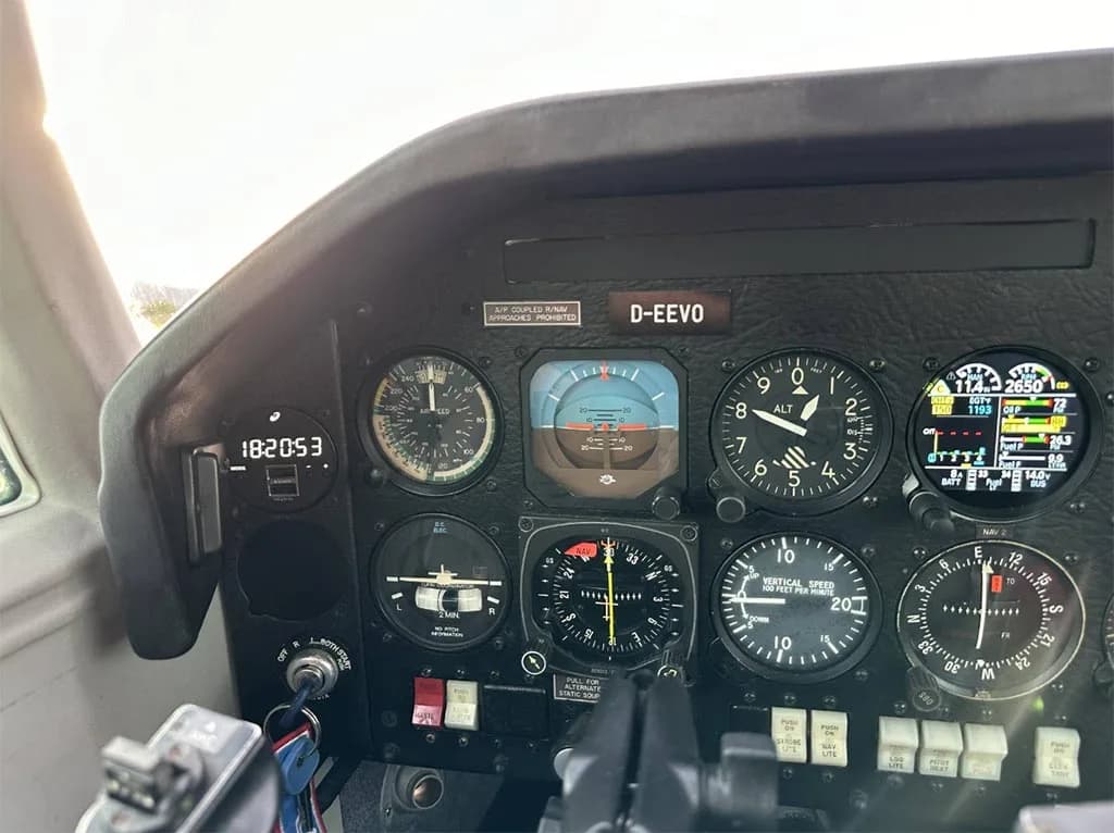 A close-up view of the Mooney M20J's primary flight instruments, including the attitude indicator and altimeter.