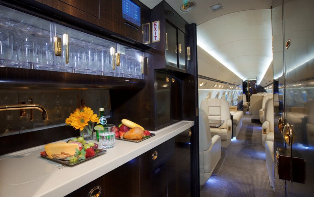 View of the aircraft interior with a bar and seating area.