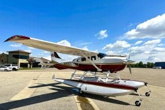 Side view of float plane N991T on the ground.