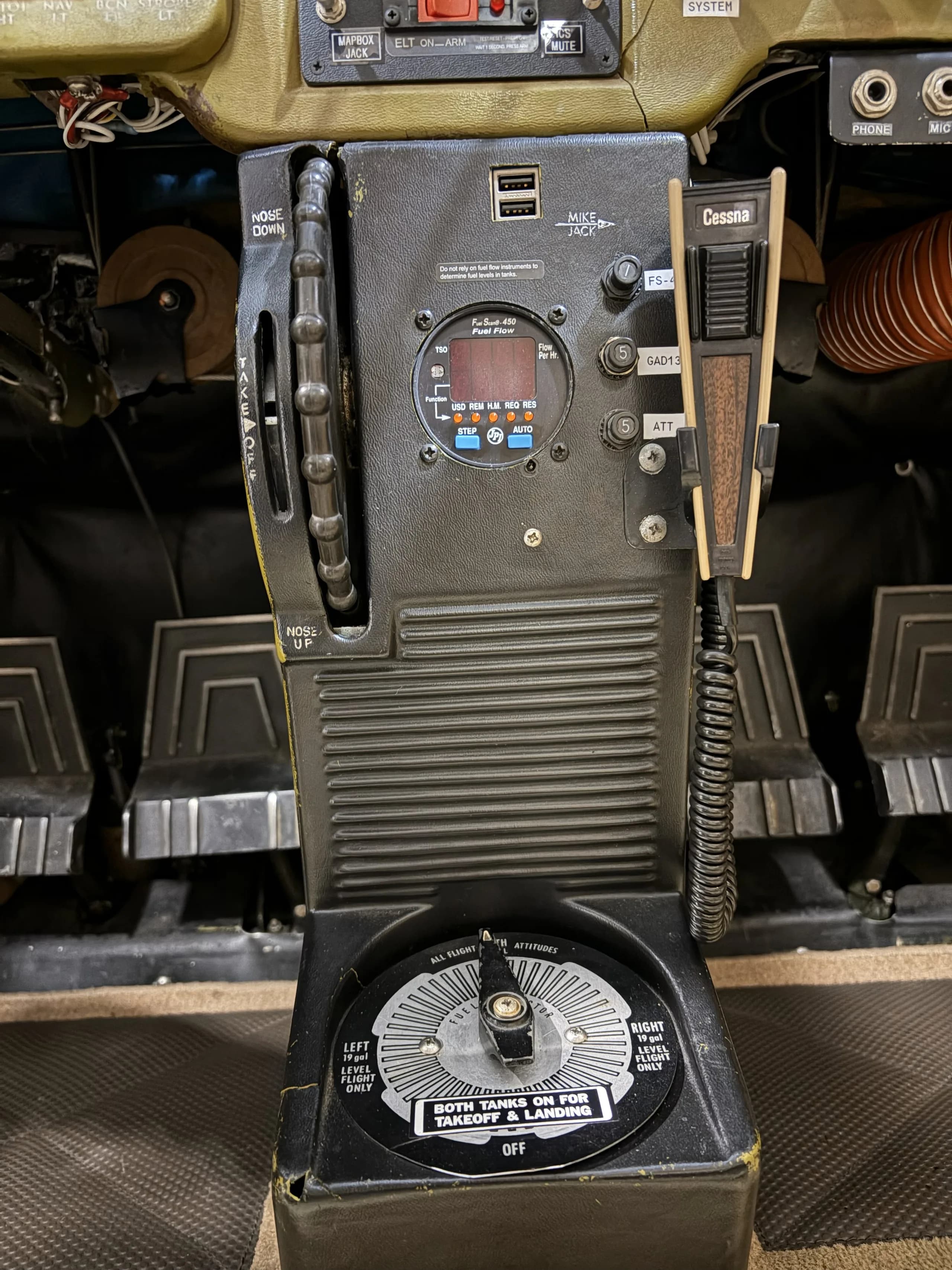 Close up of the rudder pedals and center console in the cockpit of a Cessna 172.