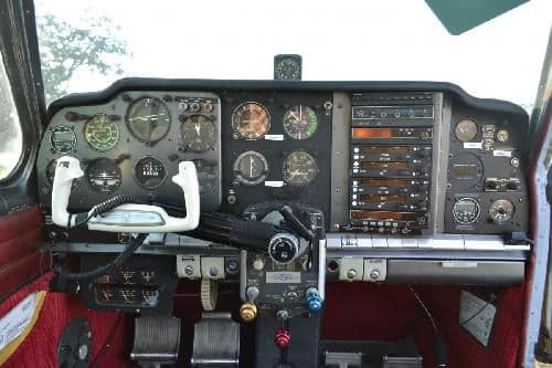 The cockpit of the aircraft shows the instrument panel and controls.