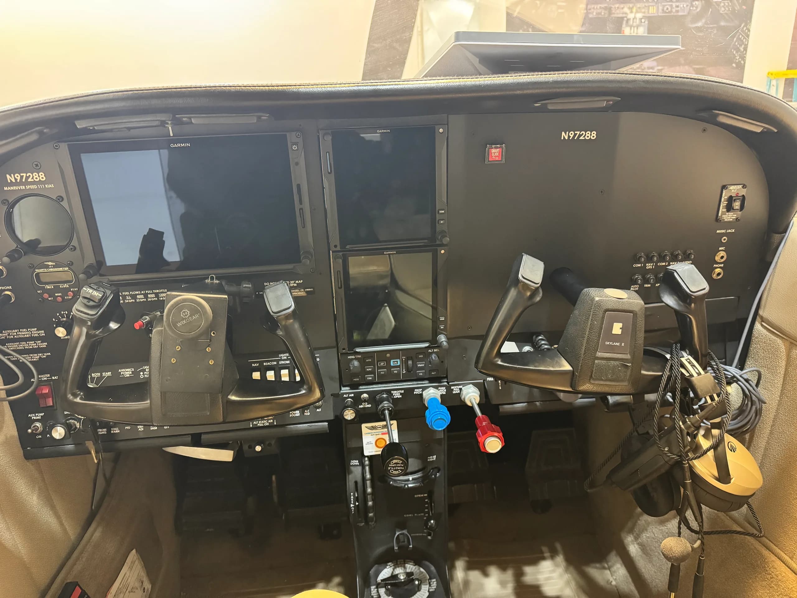The cockpit instrument panel of aircraft N97288, featuring dual Garmin displays and yokes.