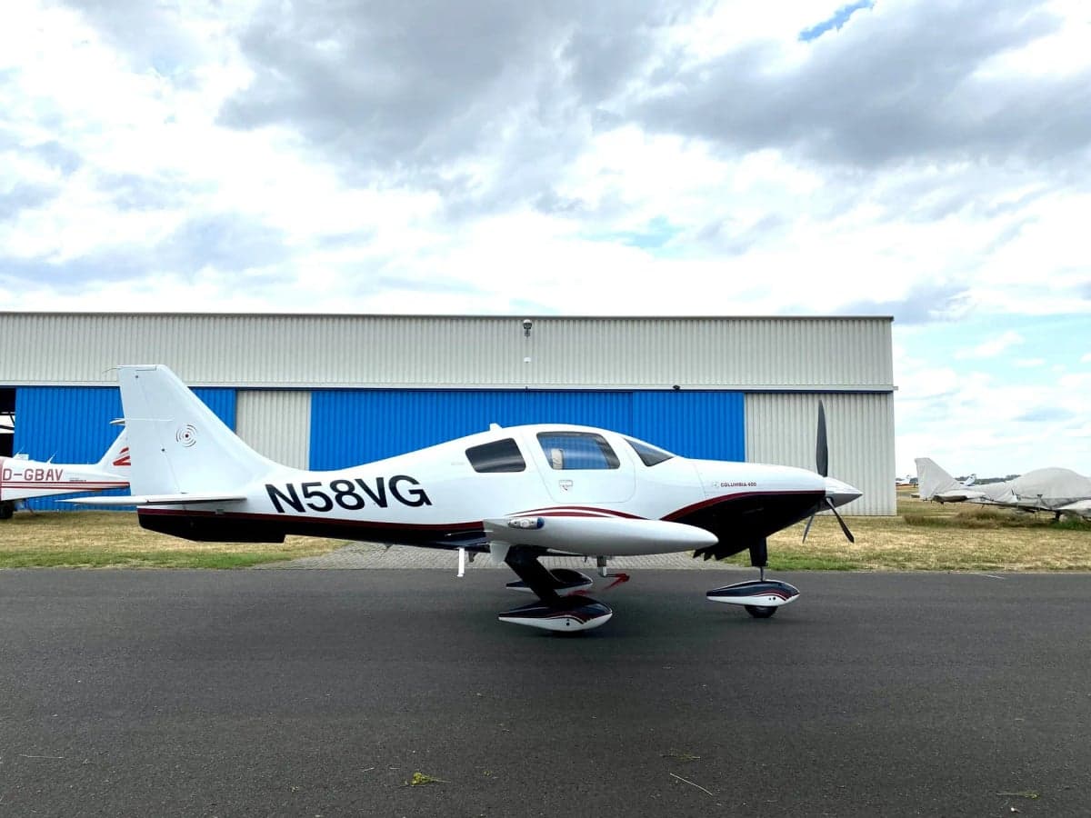 Columbia 400 aircraft N58VG parked on the tarmac with a white and brown paint scheme.