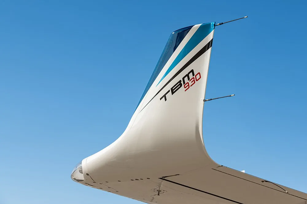 A close-up, low-angle view of the vertical stabilizer of the TBM 930 aircraft.