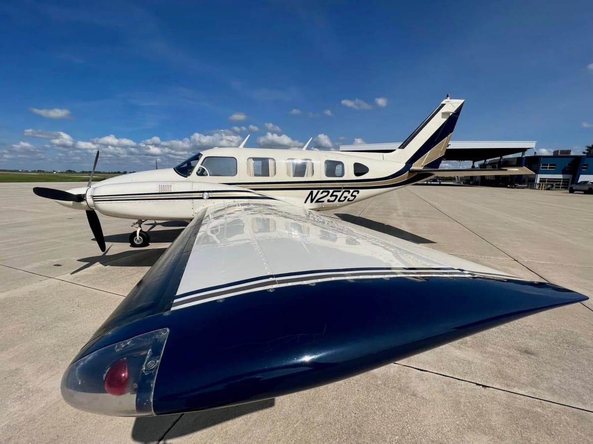 Side view of the N25GS aircraft parked on the tarmac in front of J.A. Air Center.