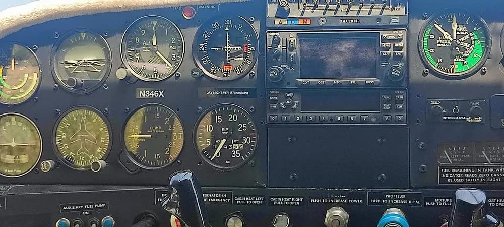 The cockpit instrument panel of N346X, featuring analog gauges and a Garmin GPS unit.