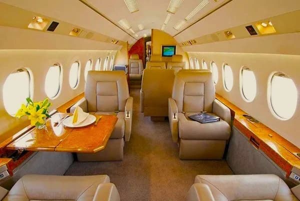 The interior of the aircraft features leather seats and wood accents.