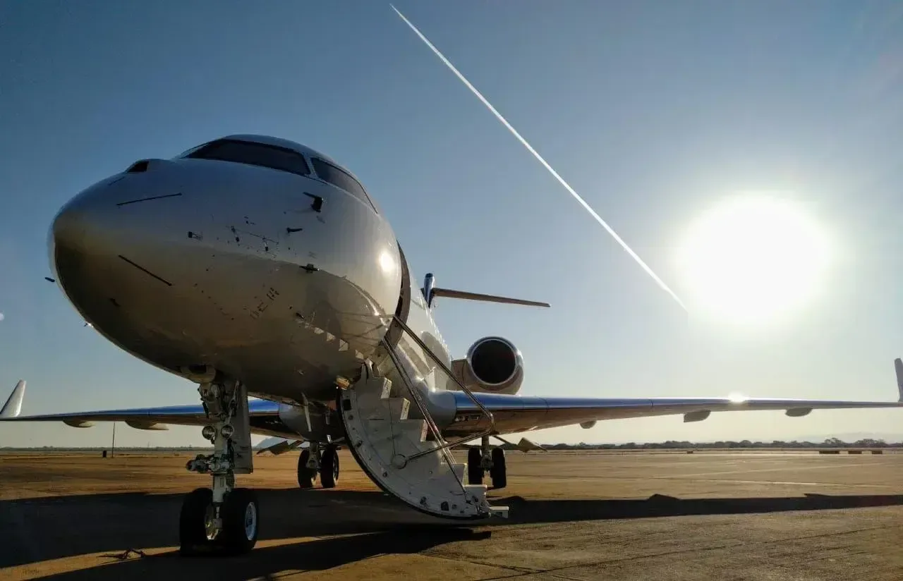 A low angle view of a Bombardier Global Express business jet parked on the tarmac.