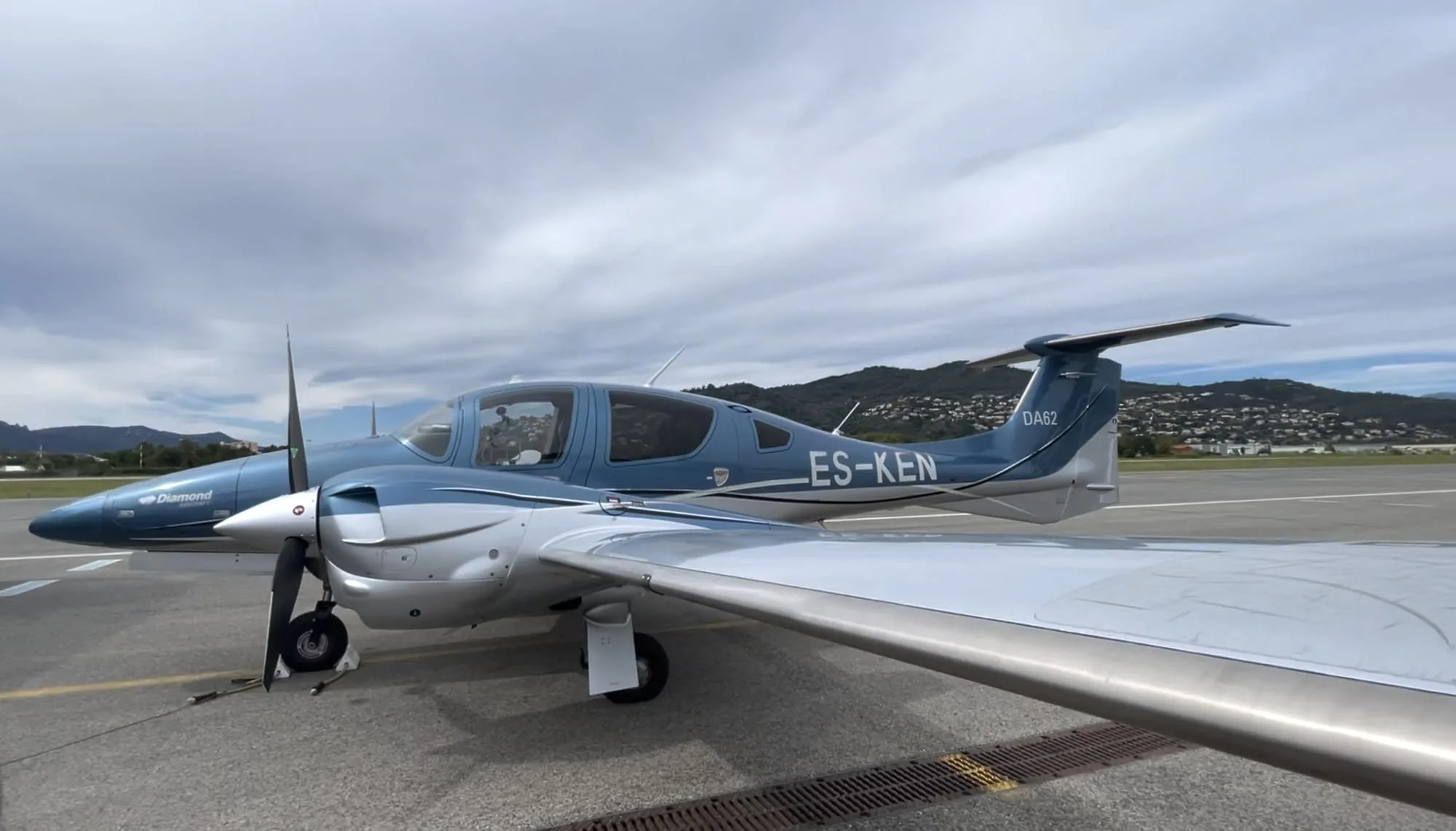 Side view of a Diamond DA62 aircraft on the tarmac.