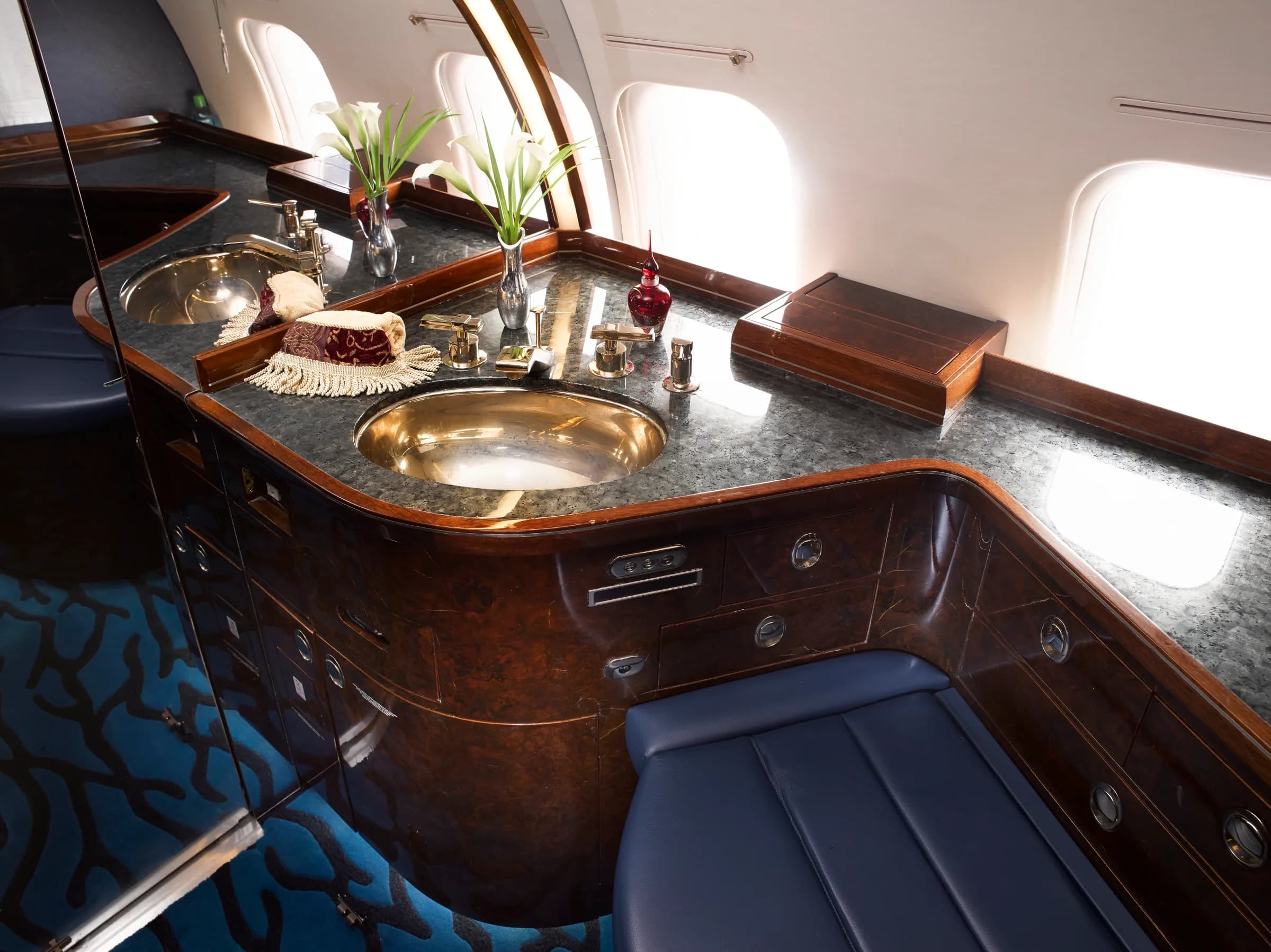 Lavatory area of the aircraft with a sink and wood accents.