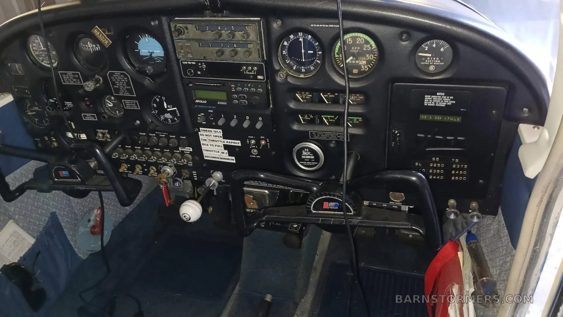 The cockpit instrument panel of a light aircraft, showing various gauges and avionics.