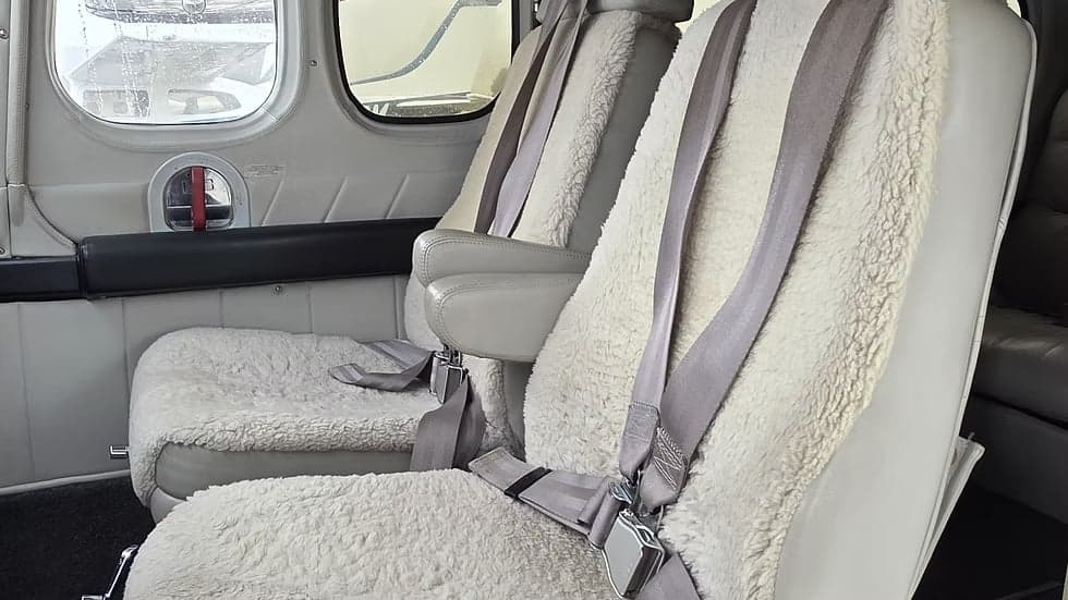 Close-up of the aircraft's interior seats with sheepskin covers.