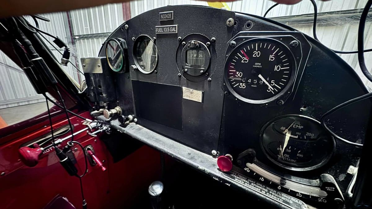 A close-up view of the vintage aircraft's instrument panel with registration N32428.