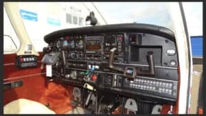 The cockpit of the aircraft featuring the instrument panel and controls.