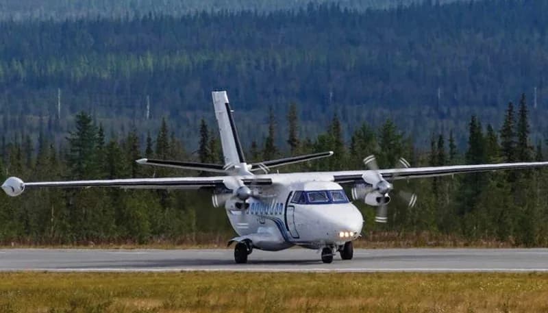A de Havilland Canada DHC-6 Twin Otter taking off from a rural airstrip.