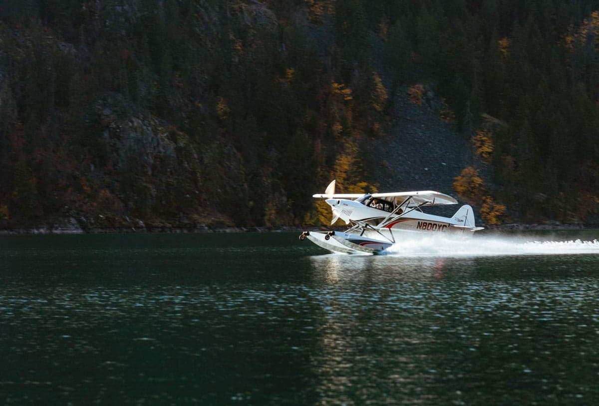 An XCub seaplane takes off from a lake.