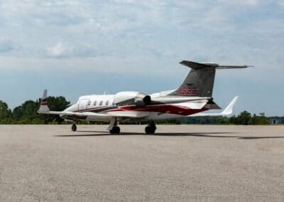 A Learjet 45XR aircraft is parked on the tarmac, showing the tail number.