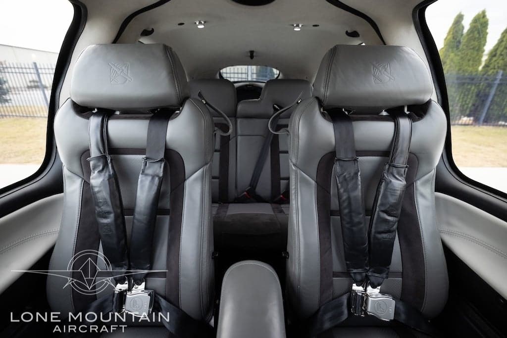 The interior of a Cirrus SR22T aircraft features gray leather seats with black accents.