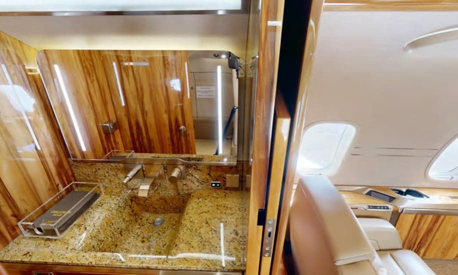 The interior of the Challenger aircraft features a lavatory with a granite countertop.