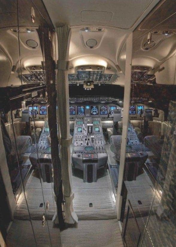 View of the aircraft cockpit with multiple displays and controls.
