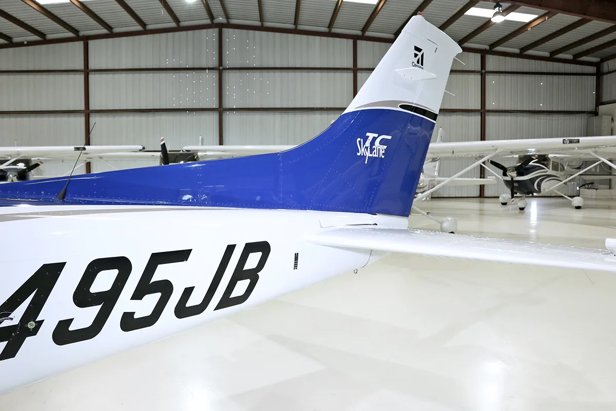 A close-up view of the tail section of a white and blue aircraft, showing the N495JB registration and "Skylane" logo.
