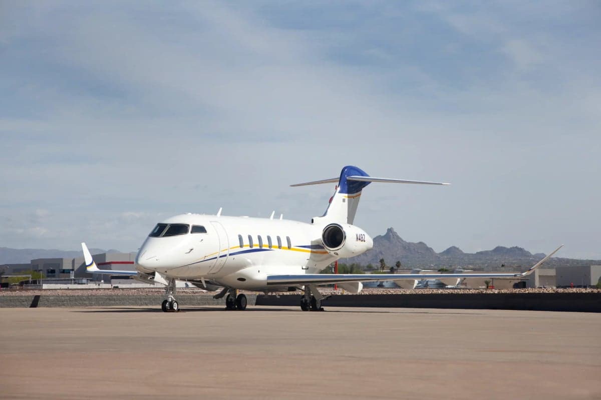 Front side view of the N4BZ aircraft on the tarmac with mountains in the background.